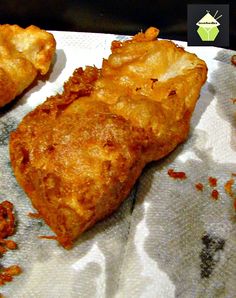 three pieces of fried food sitting on top of a napkin