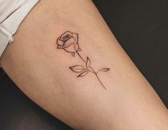 a small rose tattoo on the thigh