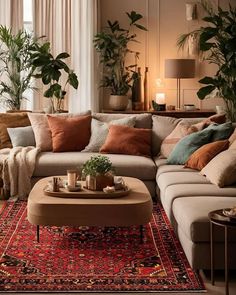 a living room filled with lots of furniture and plants on top of a red rug