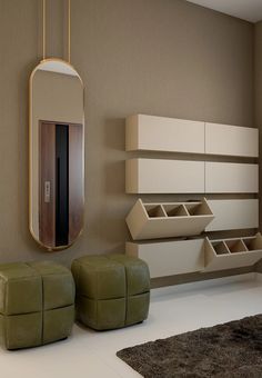 a living room filled with furniture next to a mirror and wall mounted shelf on the wall