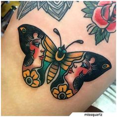 a woman's thigh with a butterfly tattoo design on her leg, and flowers