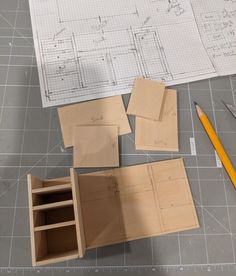 several pieces of wood sitting on top of a table next to a pencil and ruler