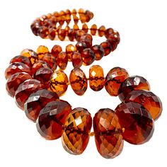 Superb, rare natural translucent faceted Baltic amber necklace of impressive size, gem quality and color reminiscent of fine rich cognac. This necklace has been tested for natural amber and has a high degree of electrical attraction. The reddish orange, vermillion color is scarcely seen in natural amber necklaces of this scale. Amber has long been associated with the power of attraction and excellent communication, as is the color red- making this necklace doubly desirable. 38.5 inches (97.8cm) Luxury Orange Gemstone Beads Jewelry, Luxury Orange Gemstone Beaded Necklaces, Unique Luxury Orange Necklaces, Luxury Citrine Amber Necklace, Luxury Amber Natural Stones, Luxury Gold Plated Amber Jewelry, Luxury Polished Amber Beads, Luxury Amber Oval Beads Jewelry, Cheap Amber Necklaces