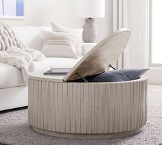 a living room with a white couch and round coffee table