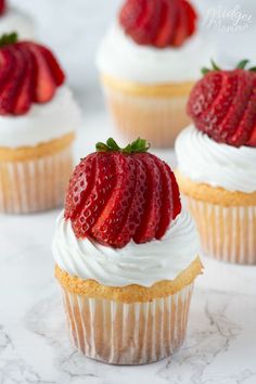 strawberry cupcakes with whipped cream and fresh strawberries on top