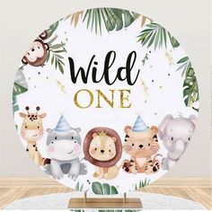 a paper plate with animals on it and the words wild one written in gold foil