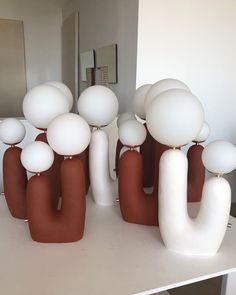 a group of white and brown objects sitting on top of a table next to a mirror