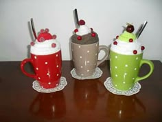 three cups filled with different types of drinks on top of a table next to each other