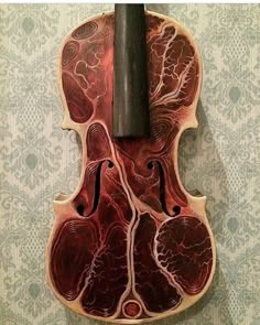 an old violin that has been made into a piece of wood and is hanging on the wall