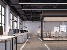 an empty office with desks and computers