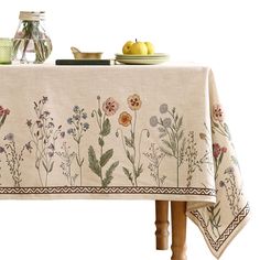 a table topped with a white table cloth covered in flowers