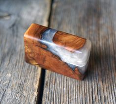 a wooden object sitting on top of a wooden table next to a piece of wood