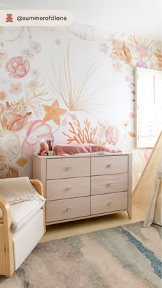 @summerofdiane’s beach-inspired nursery looks like something out of a fairytale. It features stunning sea-themed wallpaper, whimsical wicker decor, and a couple of modern organic pieces — including the Sprout Dresser. 🧡 Bali Nursery, Baby Girl Nursery Beach Theme, Beach Nursery Girl, Mermaid Nursery Baby Girl, Moana Nursery, Boho Beach Nursery, Beach Baby Rooms, Beach Themed Nursery, Sea Themed Nursery