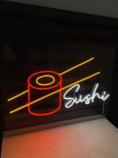 a neon sign that says sushi on the side of a building with a roll of toilet paper in it