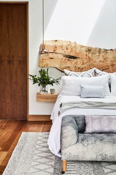 a large bed sitting in the middle of a bedroom on top of a wooden floor