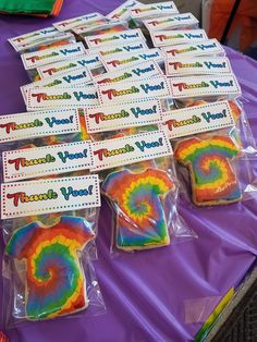 tie - dyed cookies are sitting on a purple table