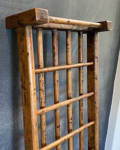 an old wooden bed frame sitting against a wall