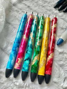 four pens are lined up next to each other on a white furnishing area