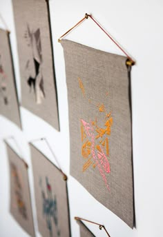 four wall hangings with different designs on them