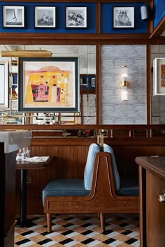 the interior of a restaurant with pictures on the wall and checkerboard flooring