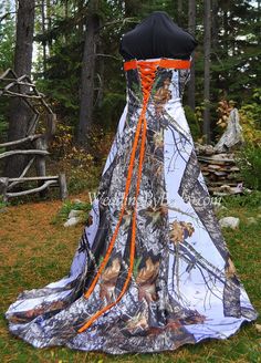 a camo wedding dress with an orange sash