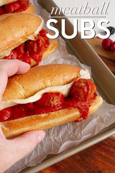 two meatball subs with marinara sauce on them