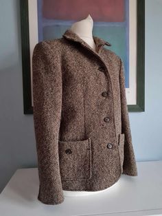 Vintage 50s/60s Brown Tweed Woven Wool Women's Jacket Cranmere Devon Made in England  Size M 34 ins Chest ( Label says 14 but please note this is vintage sizing and equivalent to a modern UK 10) Measurements taken laid flat and buttoned up:  18 ins pit to pit but will best fit a 34 ins chest  Waist  17 ins side to side on the outside but the material is tweed and true waist measurement is probably 30 ins  Hip 18 ins side to side and will best fit a 34-35 ins hip  Slightly padded shoulders 4 Butt Retro Winter Tweed Jacket With Pockets, Retro Tweed Jacket With Pockets For Winter, Retro Winter Tweed Jacket For Workwear, Retro Wool Outerwear With Lapel Collar, Retro Long-sleeved Tweed Outerwear, Retro Single-breasted Tweed Jacket For Fall, Tailored Retro Tweed Blazer, Retro Tailored Tweed Blazer, Retro Tweed Outerwear