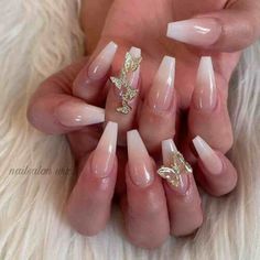 some very pretty nails with gold leaves on them and white acrylic nail polish