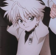 an anime character with blonde hair and blue eyes holding a white object in his hand