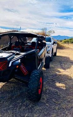 two off road vehicles parked in the desert