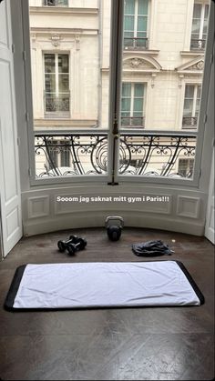 an empty gym mat sitting in front of a window