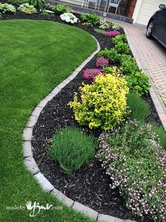 the front yard is neatly trimmed and ready to be used as a flowerbed garden