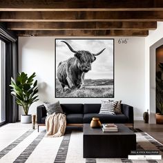 the living room is decorated in black and white with an animal print on the wall