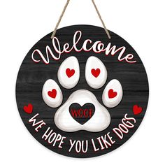 a sign that says, welcome we hope you like dogs with paw prints and hearts