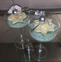 two glasses with dessert items in them on a table