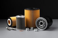 an assortment of air filters and parts on a gray surface with space for text or image