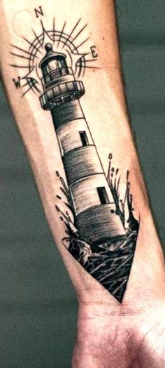 a hand with a lighthouse tattoo on it