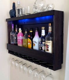 a wall mounted shelf filled with bottles and glasses