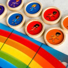 the buttons have pictures of children on them and are next to a rainbow colored surfboard