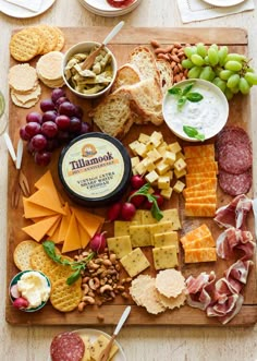 a wooden tray filled with cheese and crackers