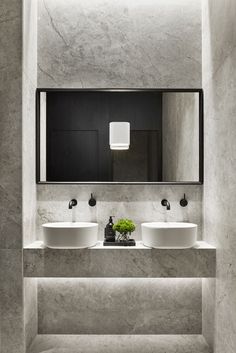 a bathroom with two sinks and a mirror