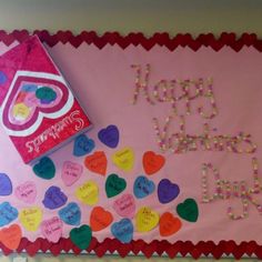 a birthday cake with candy hearts on it and a sign that says you're happy