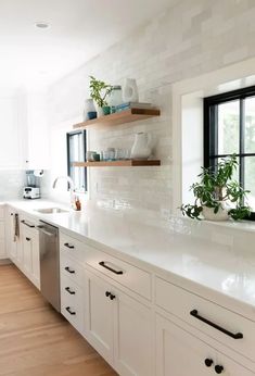 a kitchen filled with lots of white counter top space