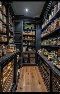 a large pantry with lots of food and spices in it's shelves, along with wooden flooring