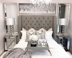 a bedroom with a bed, nightstands and chandelier