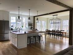 an open kitchen and dining room with hardwood floors