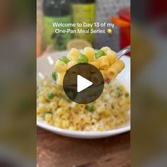 a white plate topped with pasta and peas