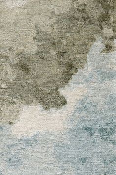 an area rug with water and clouds on the ground in shades of blue, green, beige and white