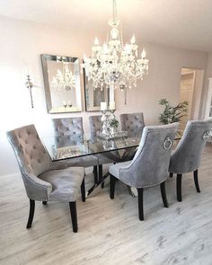 a dining room table with chairs and a chandelier