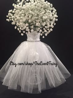 a bouquet of white baby's breath flowers in a wedding dress with tulle